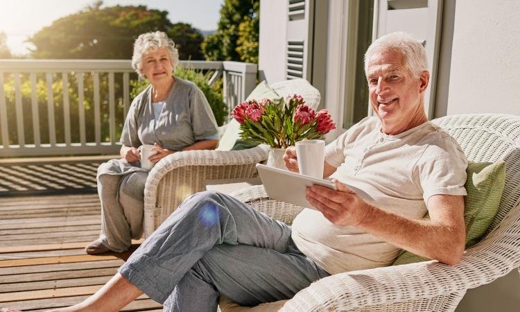 happy retirees enjoying coffee on the porch