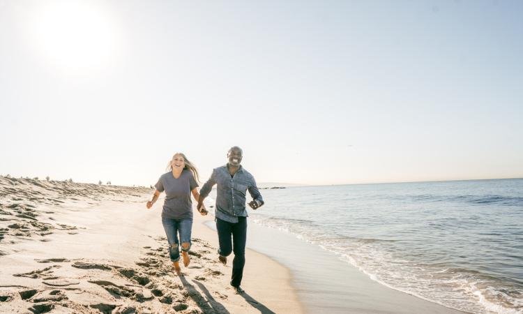 happy retired couple on the beach in virginia