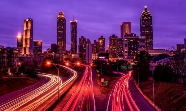 busy roadway in atlanta georgia with city skyline in background