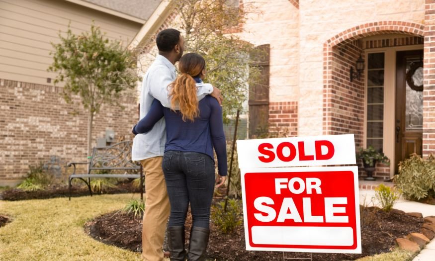 New home buyers standing outside a new construction home in florida they just bought