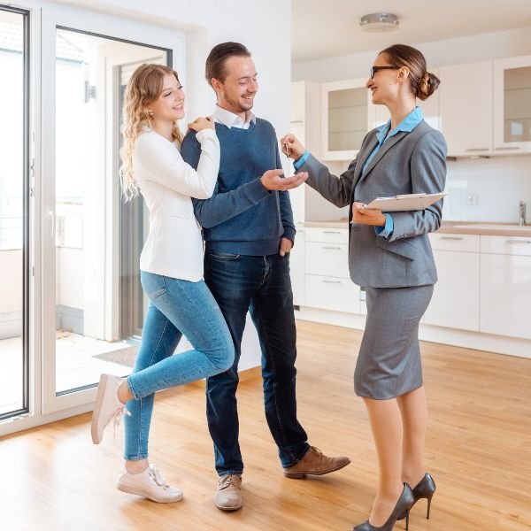 happy couple buying a home with real estate agent