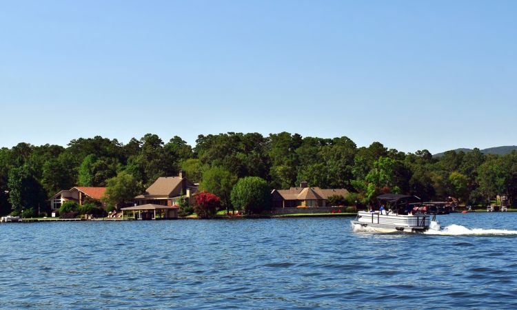 retirees in a boat returning to their lakefront home in arkansas